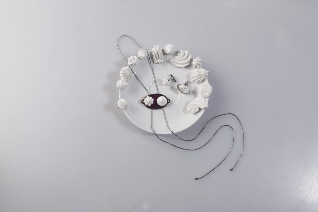 The Aftertaste collection is based on the aesthetics of meringues and delicate desserts, whose shapes are transformed into porcelain jewelry. The combination of modeling porcelain and white brass creates a contrast between fragile fluffiness and a cool metal surface inspired by dessert and confectionery dishes.